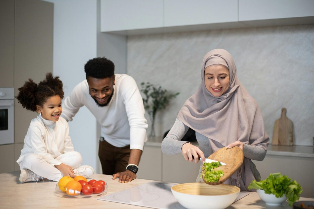 A family preparing food together in a kitchen, where most choking incidents happen at mealtimes