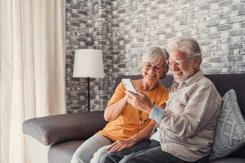 An older couple looking at the MedibandPlus medical profile together on a phone